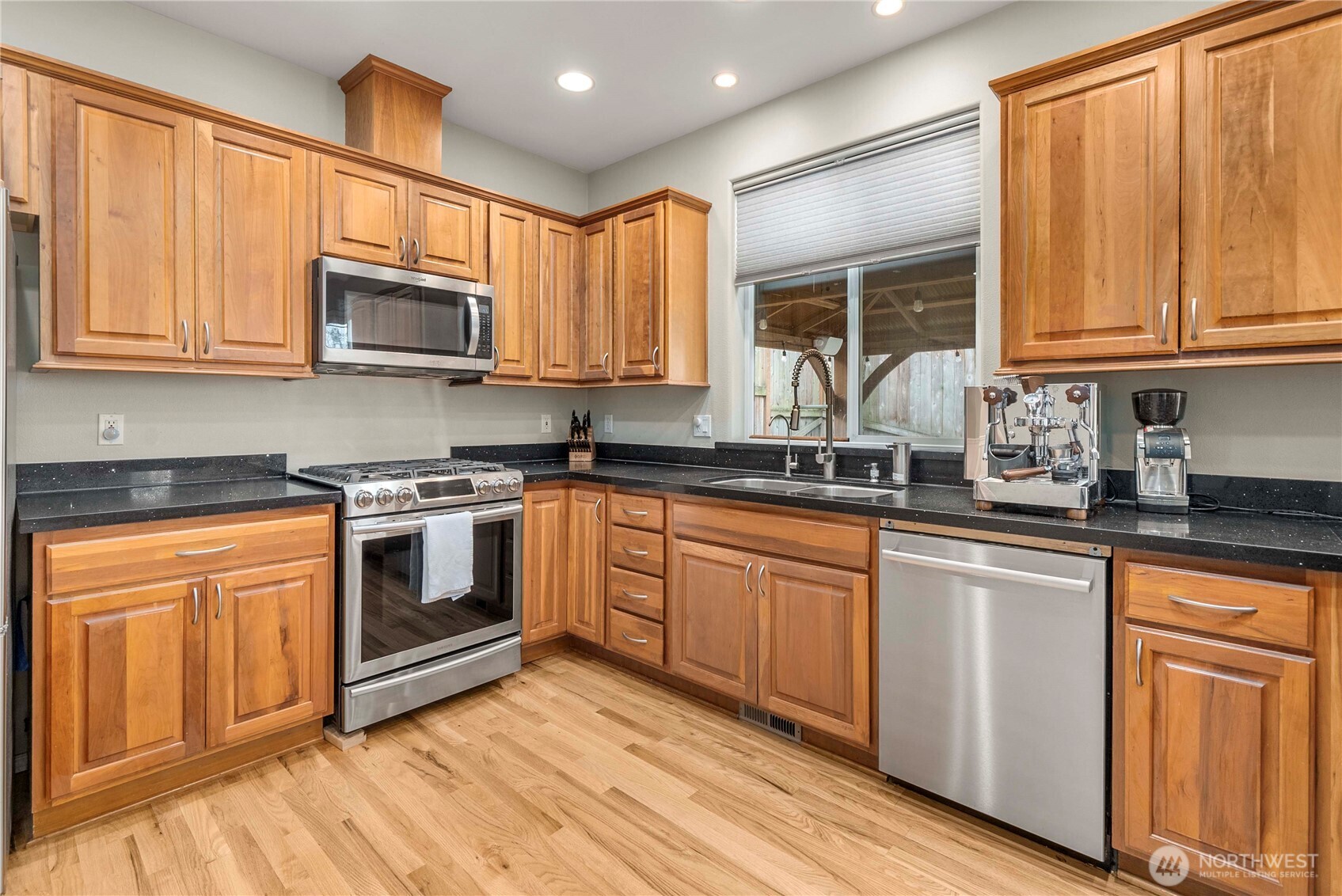 3723 Lincoln Court Northeast Renton, WA 98056 - Photo 6 of 37 a kitchen with stainless steel appliances granite countertop a stove a sink dishwasher and a microwave oven with cabinets