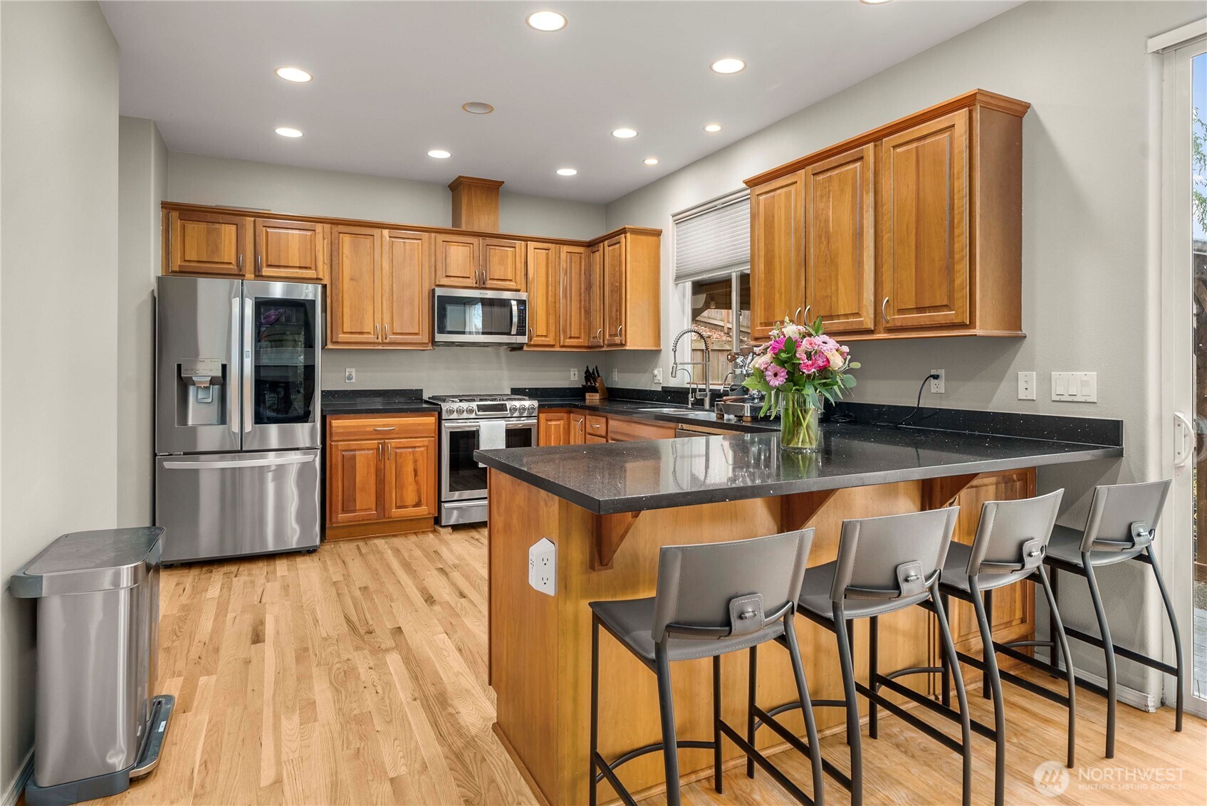 3723 Lincoln Court Northeast Renton, WA 98056 - Photo 7 of 37 a kitchen with stainless steel appliances granite countertop a stove top oven a sink dishwasher and a refrigerator with wooden floor