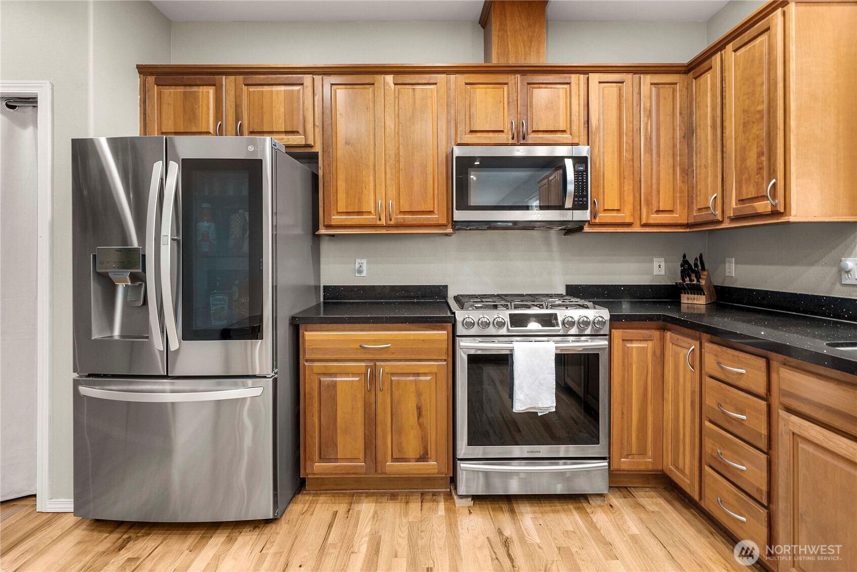 3723 Lincoln Court Northeast Renton, WA 98056 - Photo 8 of 37 a kitchen with granite countertop a refrigerator stove and microwave