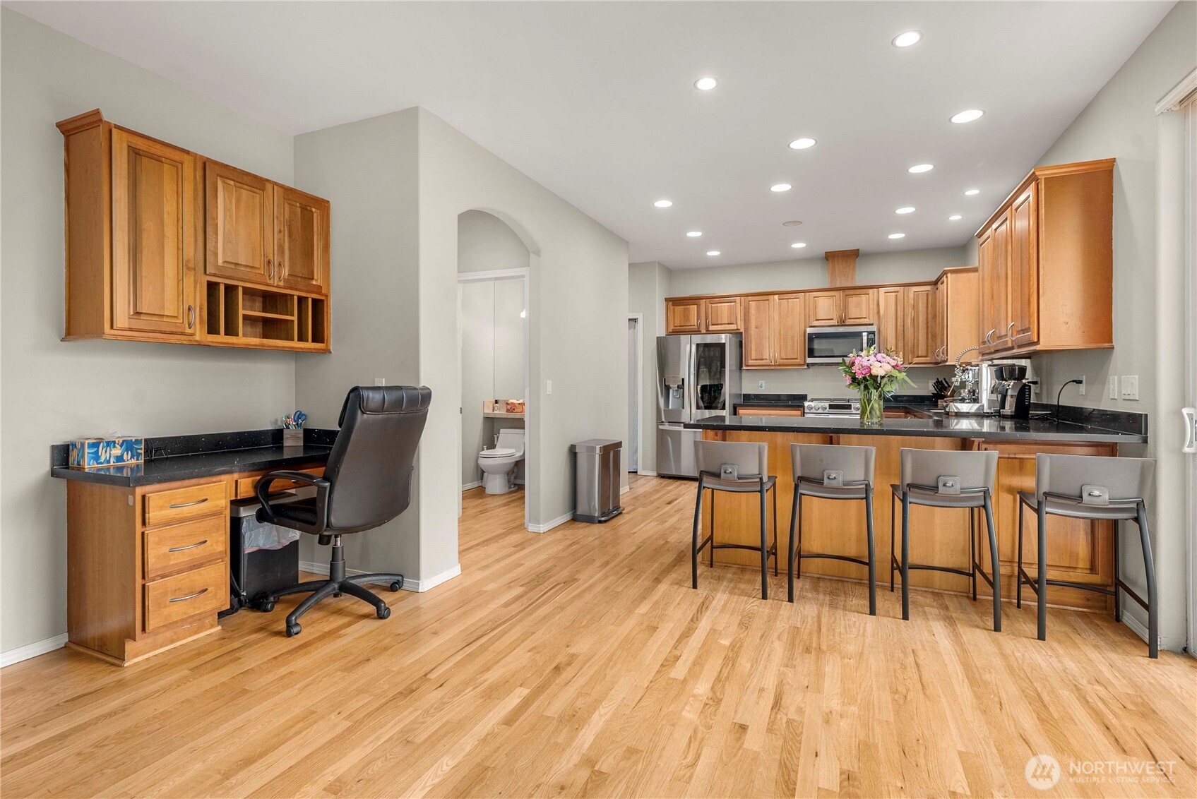 3723 Lincoln Court Northeast Renton, WA 98056 - Photo 10 of 37 a kitchen with stainless steel appliances kitchen island granite countertop a dining table chairs and a refrigerator