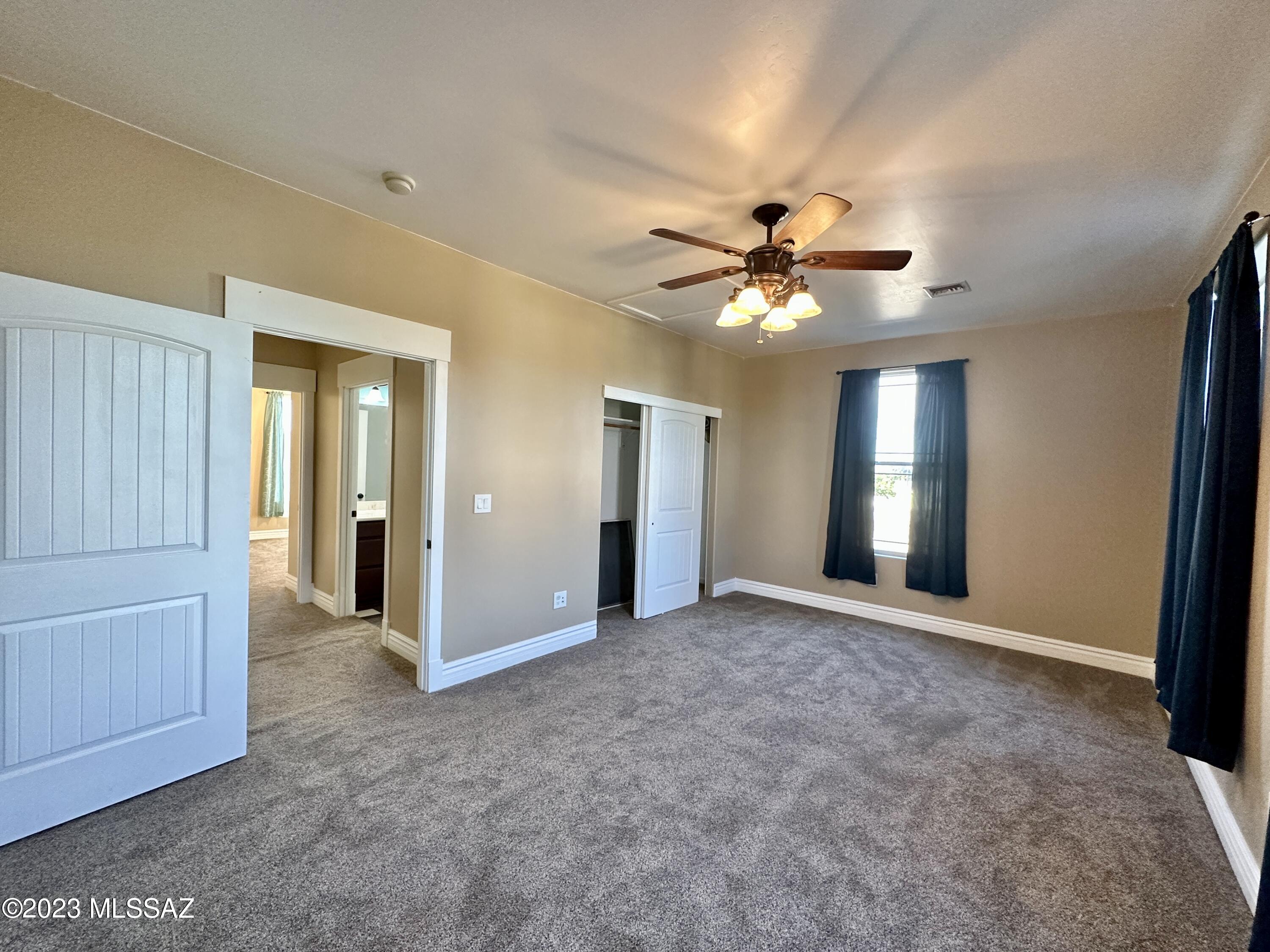 508 Eagle Meadow Loop Thatcher, AZ 85552 - Photo 20 of 32 an empty room with chandelier fan and windows