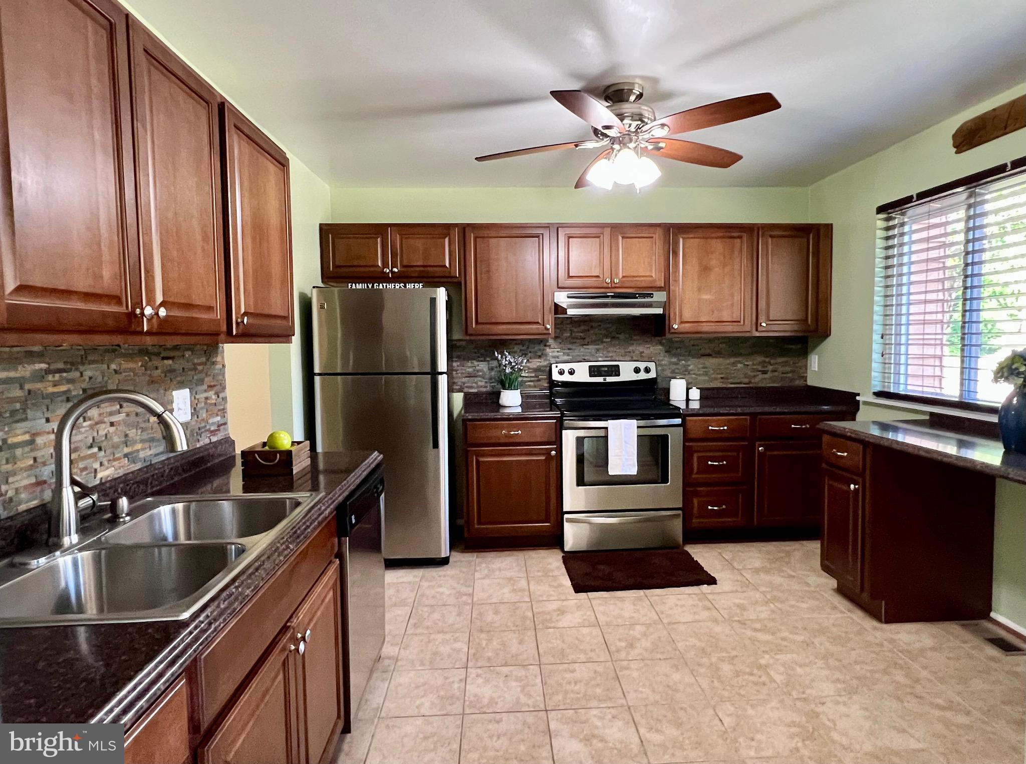1010 Commanders Way North Annapolis, MD 21409 - Photo 5 of 33 a kitchen with granite countertop a refrigerator stove top oven and sink