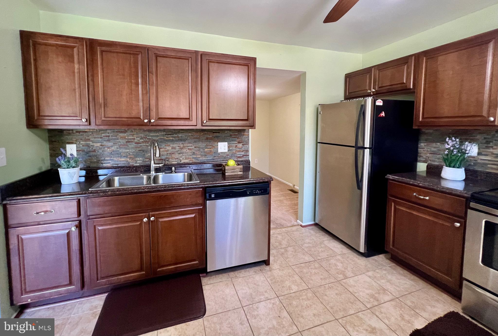 1010 Commanders Way North Annapolis, MD 21409 - Photo 6 of 33 a kitchen with stainless steel appliances granite countertop a refrigerator stove top oven and sink