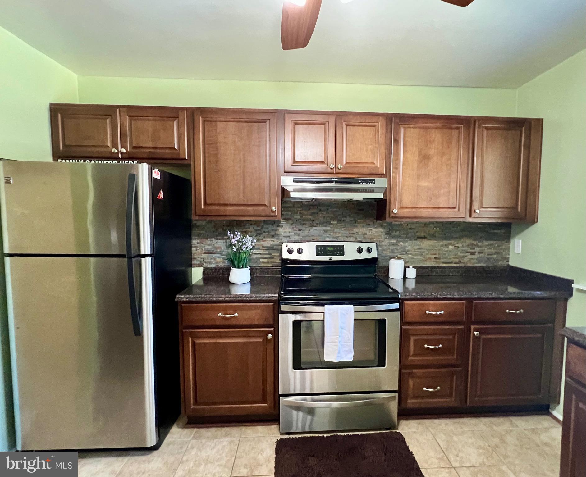 1010 Commanders Way North Annapolis, MD 21409 - Photo 7 of 33 a kitchen with stainless steel appliances granite countertop a refrigerator stove and a sink
