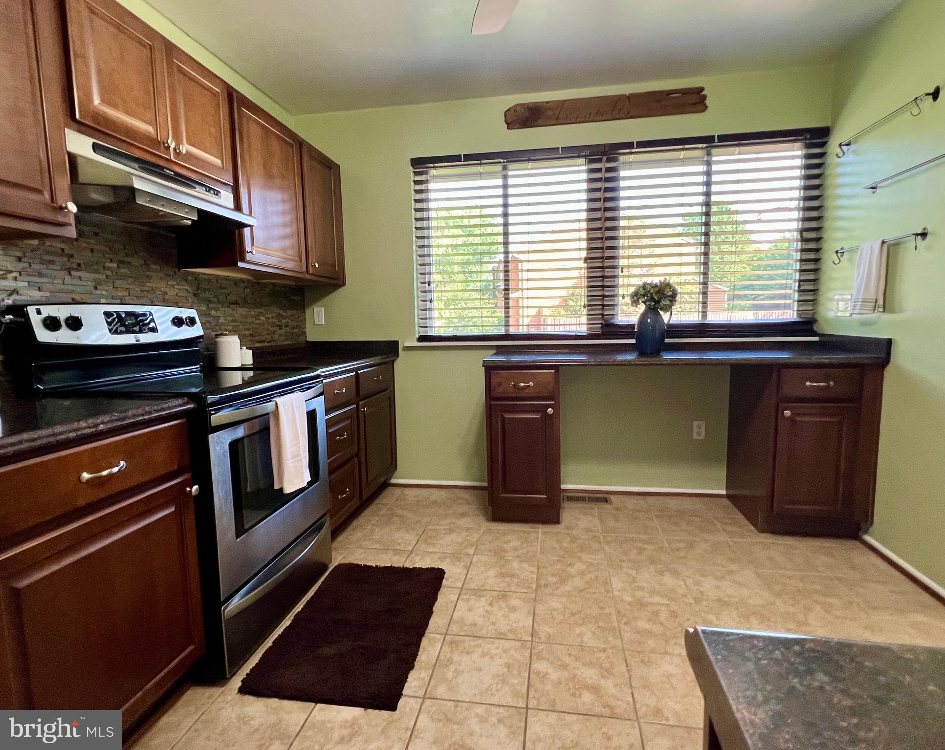1010 Commanders Way North Annapolis, MD 21409 - Photo 8 of 33 a kitchen with stainless steel appliances granite countertop a stove a sink and a microwave