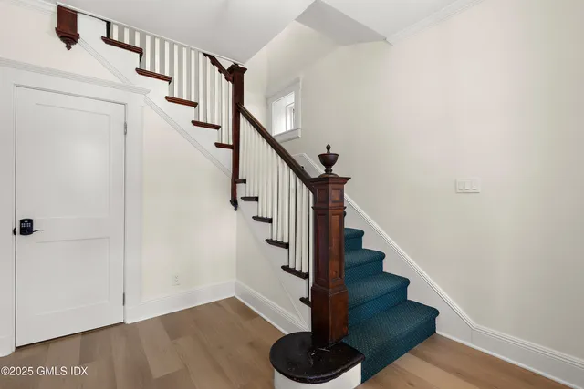 a view of entryway and gallery with wooden floor