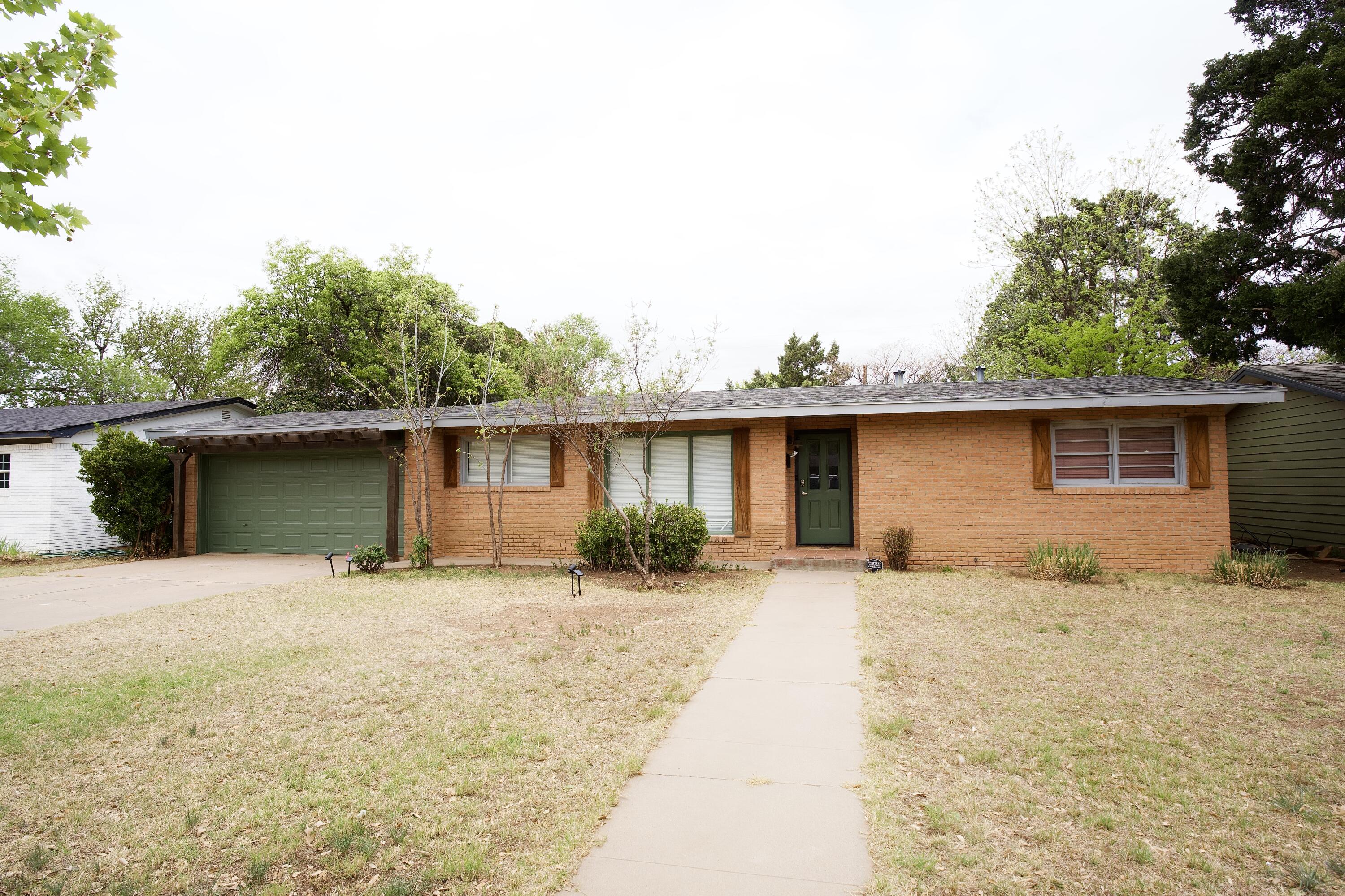3412 42nd Street Lubbock, TX 79413 - Photo 1 of 17 a backyard of a house with yard and lake view