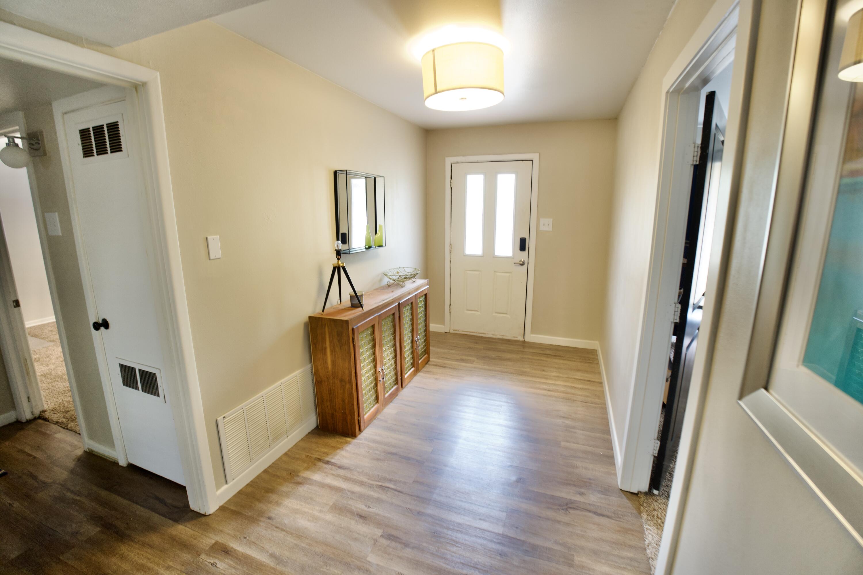 3412 42nd Street Lubbock, TX 79413 - Photo 14 of 17 a view of a hallway with wooden floor and staircase