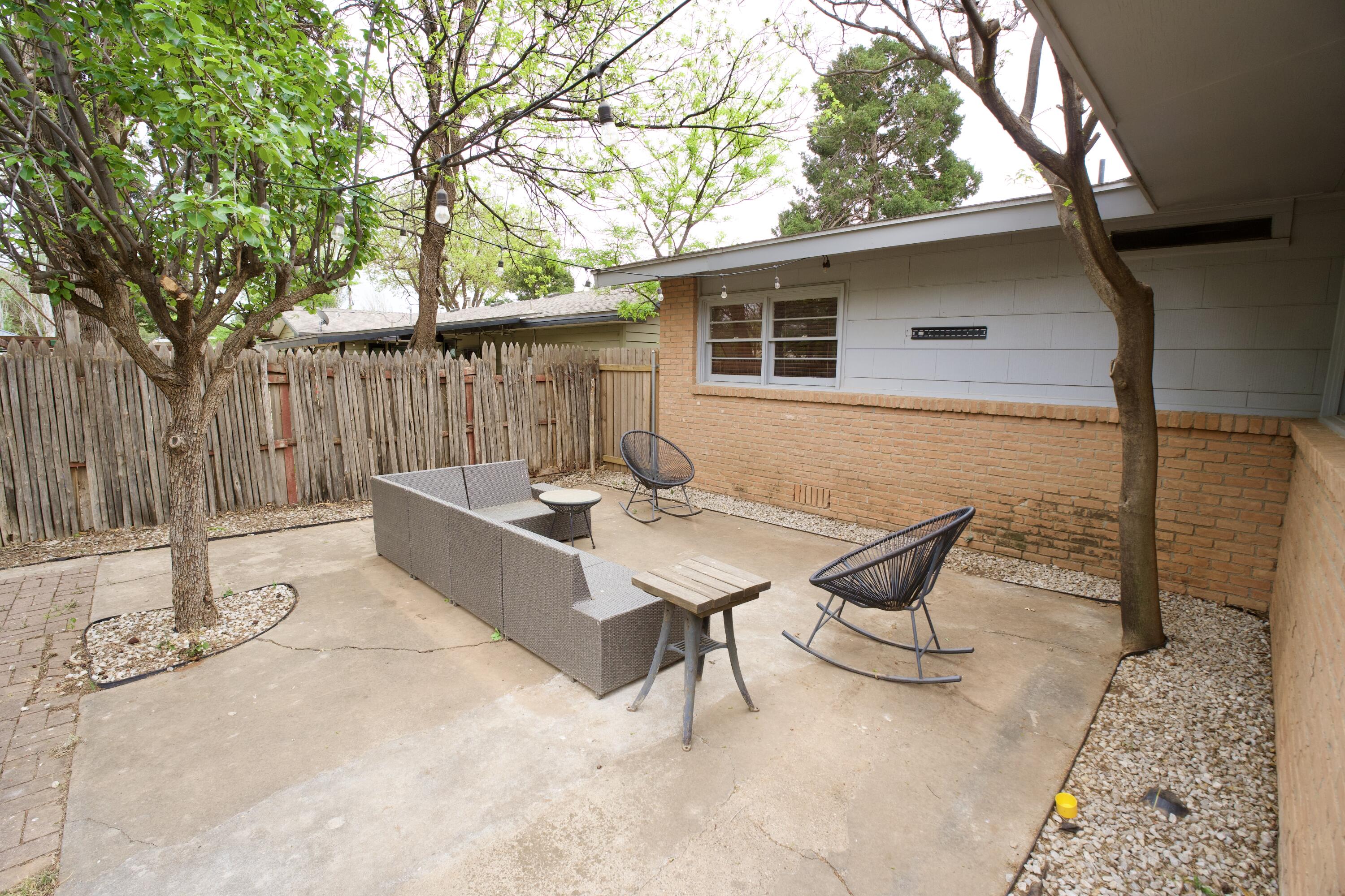3412 42nd Street Lubbock, TX 79413 - Photo 16 of 17 a backyard of a house with table and chairs