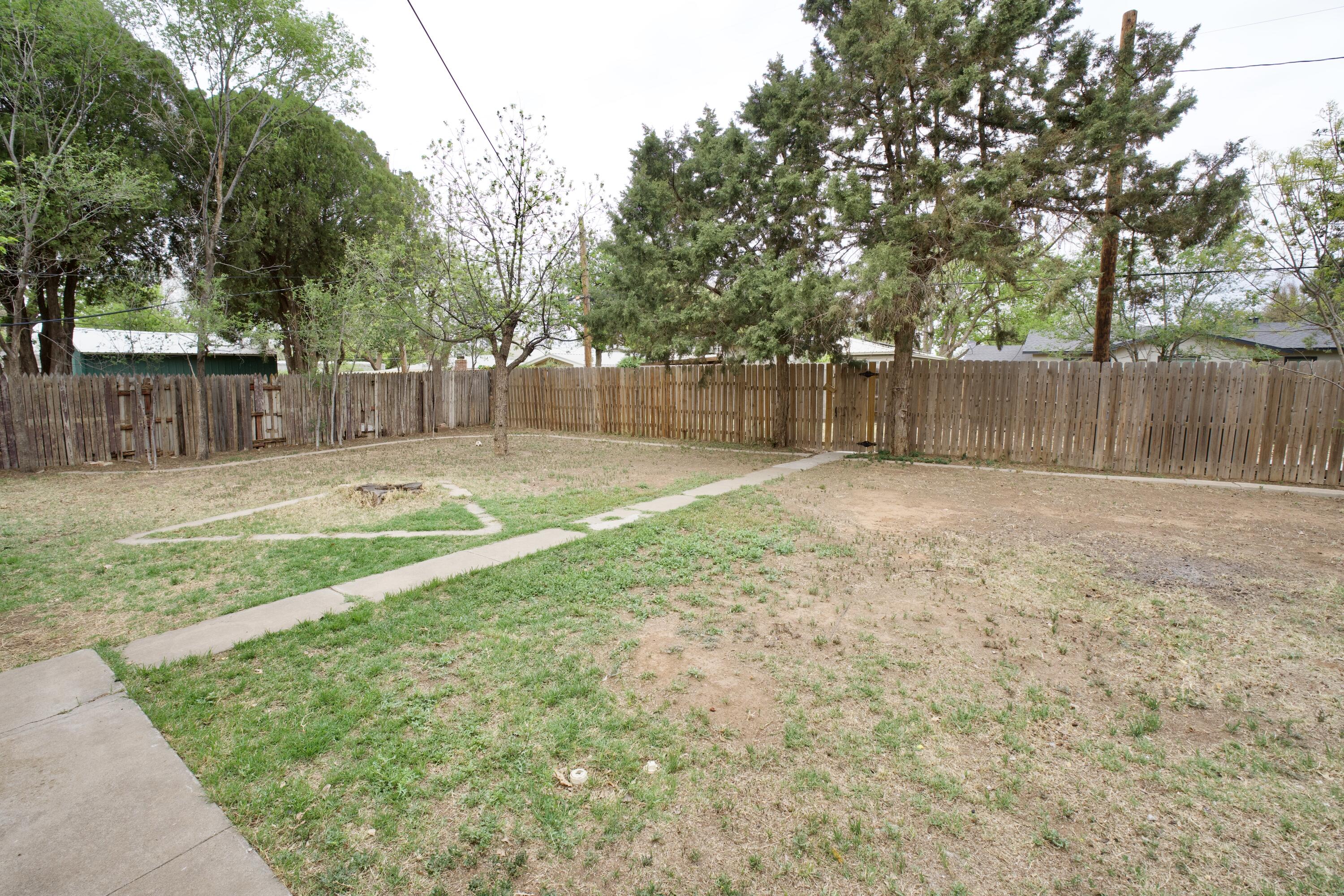 3412 42nd Street Lubbock, TX 79413 - Photo 17 of 17 a swimming pool with a yard and wooden fence