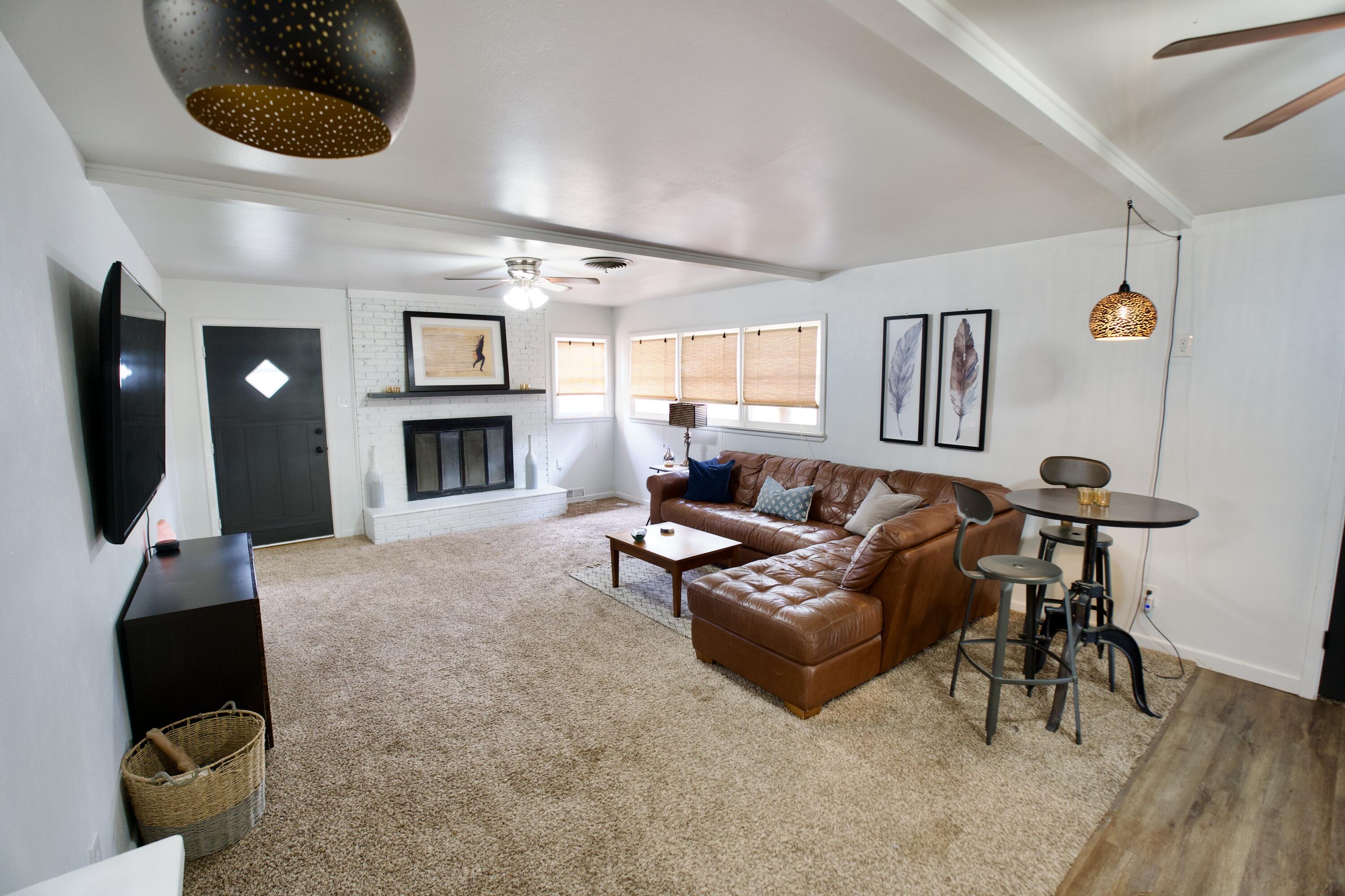 3412 42nd Street Lubbock, TX 79413 - Photo 5 of 17 a living room with furniture and a fireplace