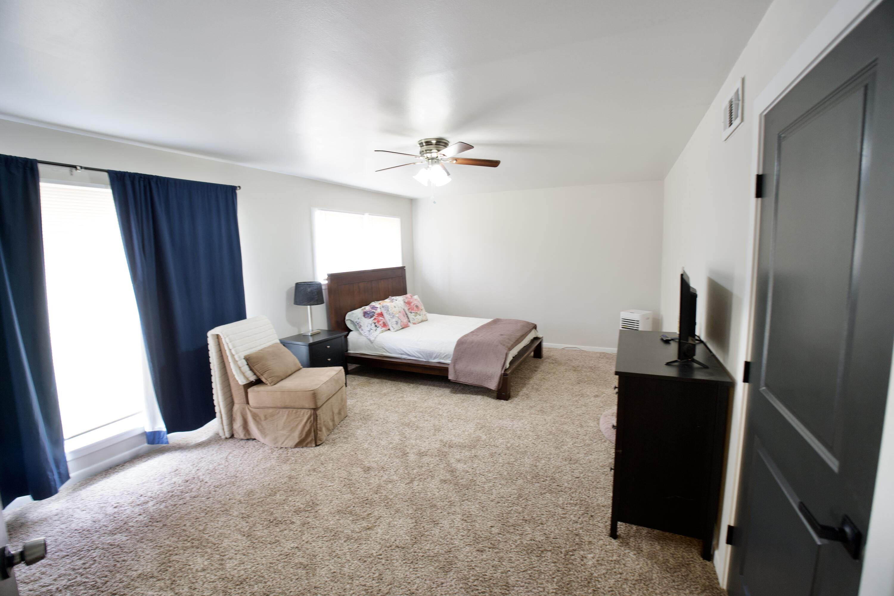3412 42nd Street Lubbock, TX 79413 - Photo 8 of 17 a bedroom with furniture and a window