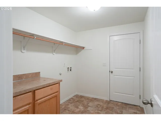 a kitchen with cabinets and wooden floor