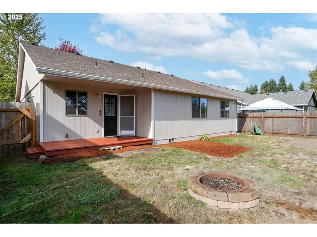 a view of a yard with wooden fence