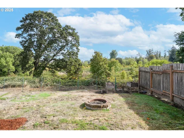 a backyard of a house with table and chairs