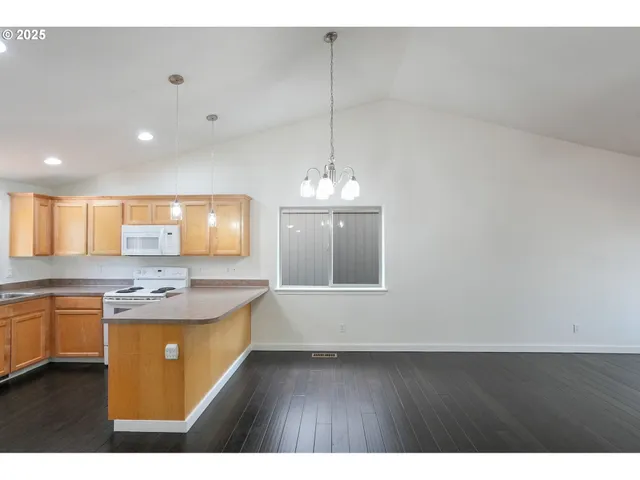 a kitchen with kitchen island white cabinets appliances and a sink