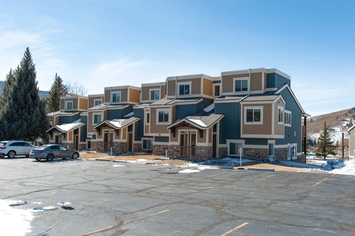 58 Summit Drive, Unit D9 Dillon, CO 80435 - Photo 17 of 34 View of front of house featuring uncovered parking and stone siding