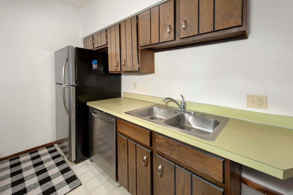 58 Summit Drive, Unit D9 Dillon, CO 80435 - Photo 27 of 34 Kitchen with stainless steel appliances, light countertops, light flooring, and dark wood finish cabinets