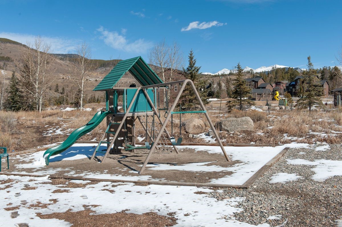 58 Summit Drive, Unit D9 Dillon, CO 80435 - Photo 31 of 34 Snow covered playground featuring a playground and a mountain view