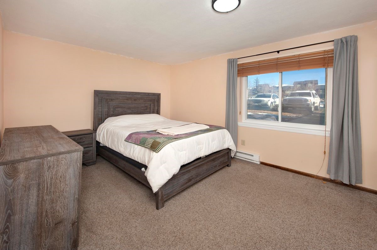 58 Summit Drive, Unit D9 Dillon, CO 80435 - Photo 7 of 34 Carpeted bedroom with baseboard heating and baseboards