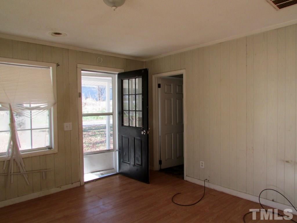 58 A & 58b Thaxton Road Roxboro, NC 27573 - Photo 11 of 16 an empty room with wooden floor and windows