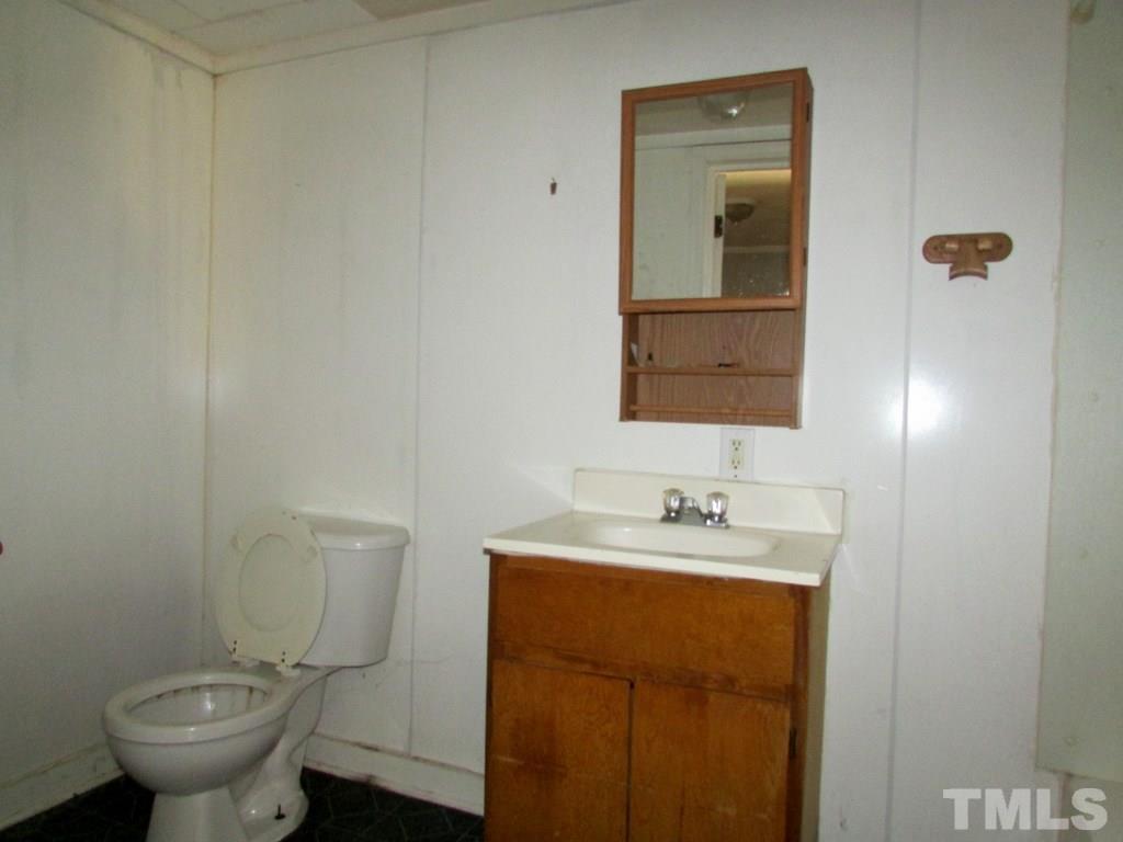 58 A & 58b Thaxton Road Roxboro, NC 27573 - Photo 13 of 16 a bathroom with a toilet sink and mirror