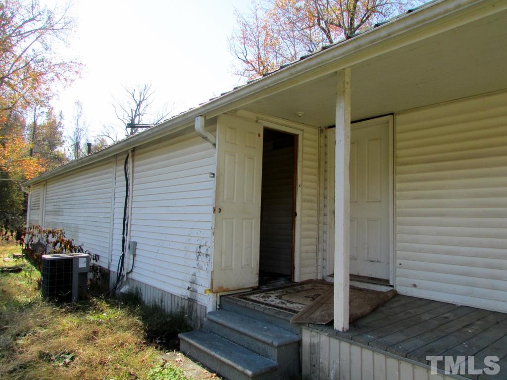58 A & 58b Thaxton Road Roxboro, NC 27573 - Photo 16 of 16 a backyard of a house with wooden fence and a refrigerator
