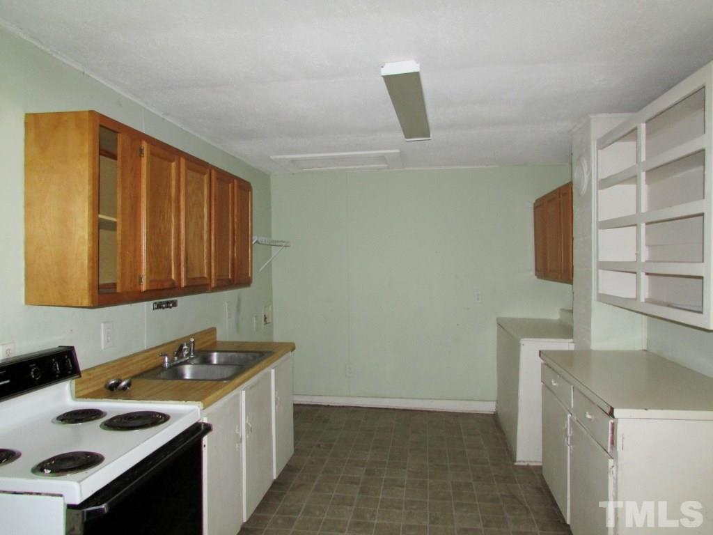58 A & 58b Thaxton Road Roxboro, NC 27573 - Photo 3 of 16 a kitchen with a sink and a stove top oven