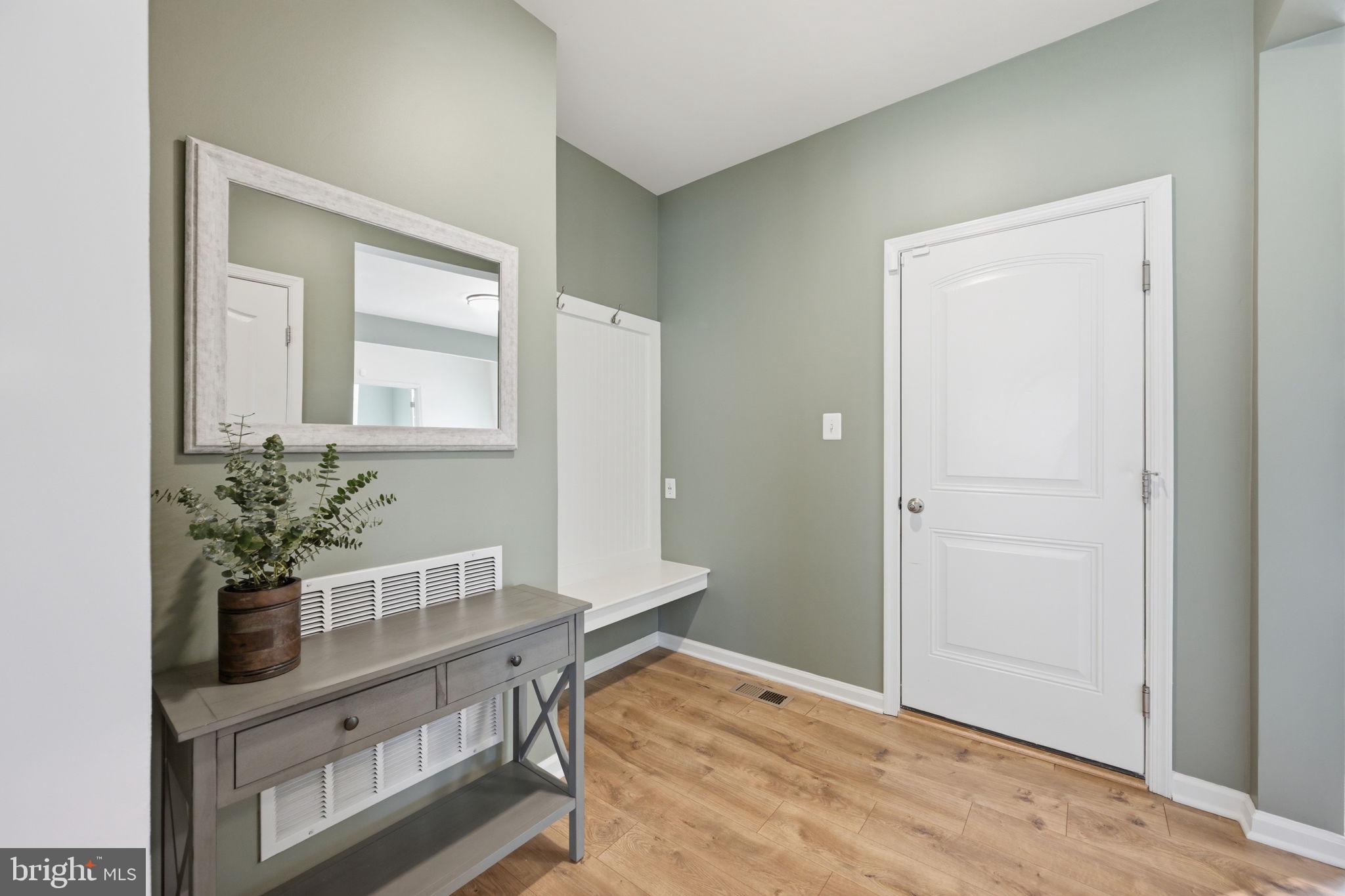2397 Terrapin Crossing Jessup, MD 20794 - Photo 12 of 40 a room with painting on the wall and a potted plant
