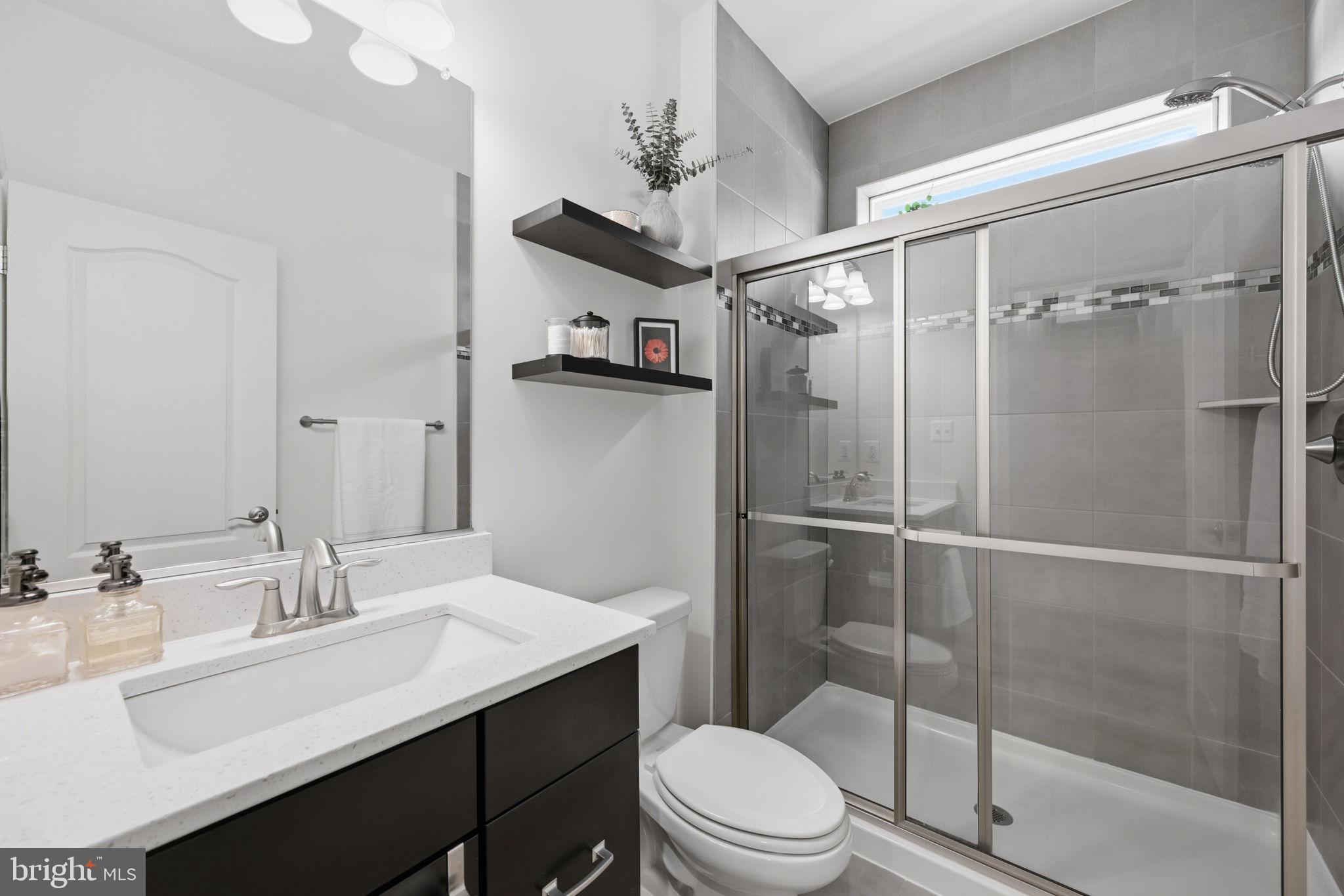 2397 Terrapin Crossing Jessup, MD 20794 - Photo 19 of 40 a bathroom with a sink toilet a mirror and shower
