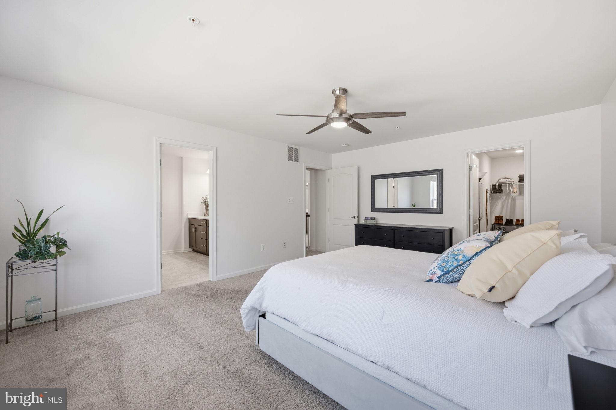 2397 Terrapin Crossing Jessup, MD 20794 - Photo 21 of 40 a bedroom with a large bed and a chandelier