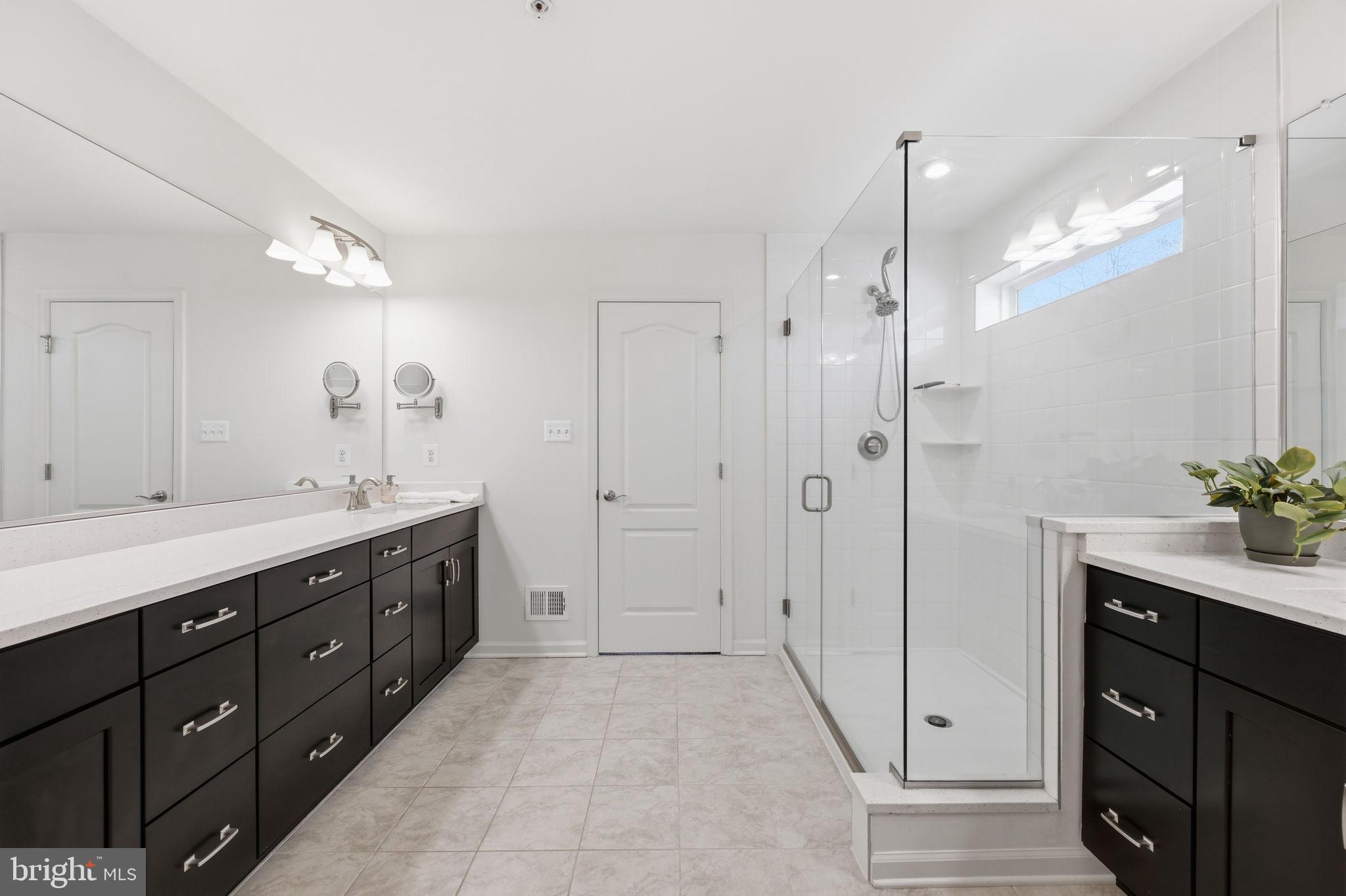 2397 Terrapin Crossing Jessup, MD 20794 - Photo 24 of 40 a spacious bathroom with a granite countertop sink mirror and a shower