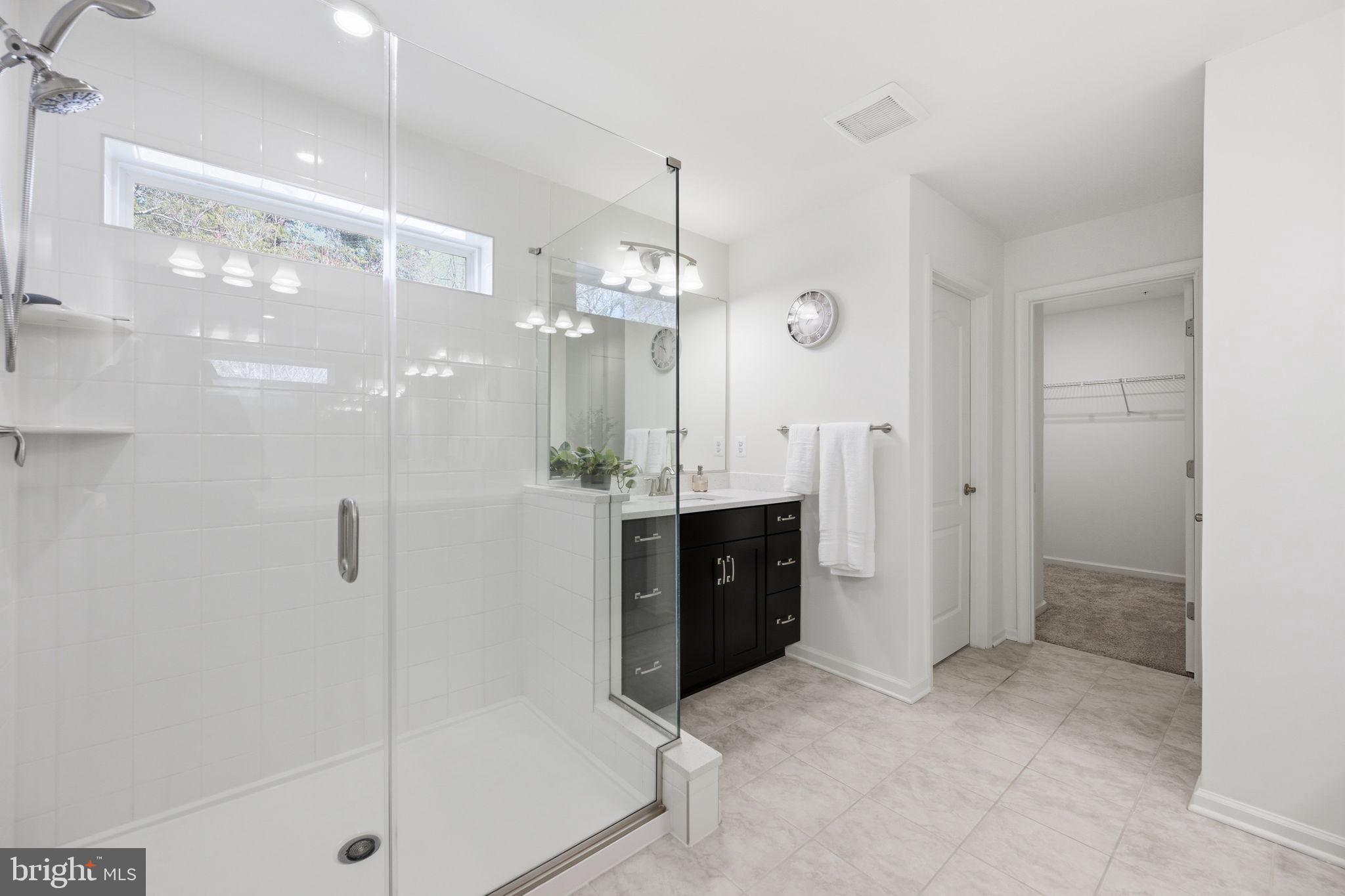 2397 Terrapin Crossing Jessup, MD 20794 - Photo 25 of 40 a spacious bathroom with a shower sink and mirror