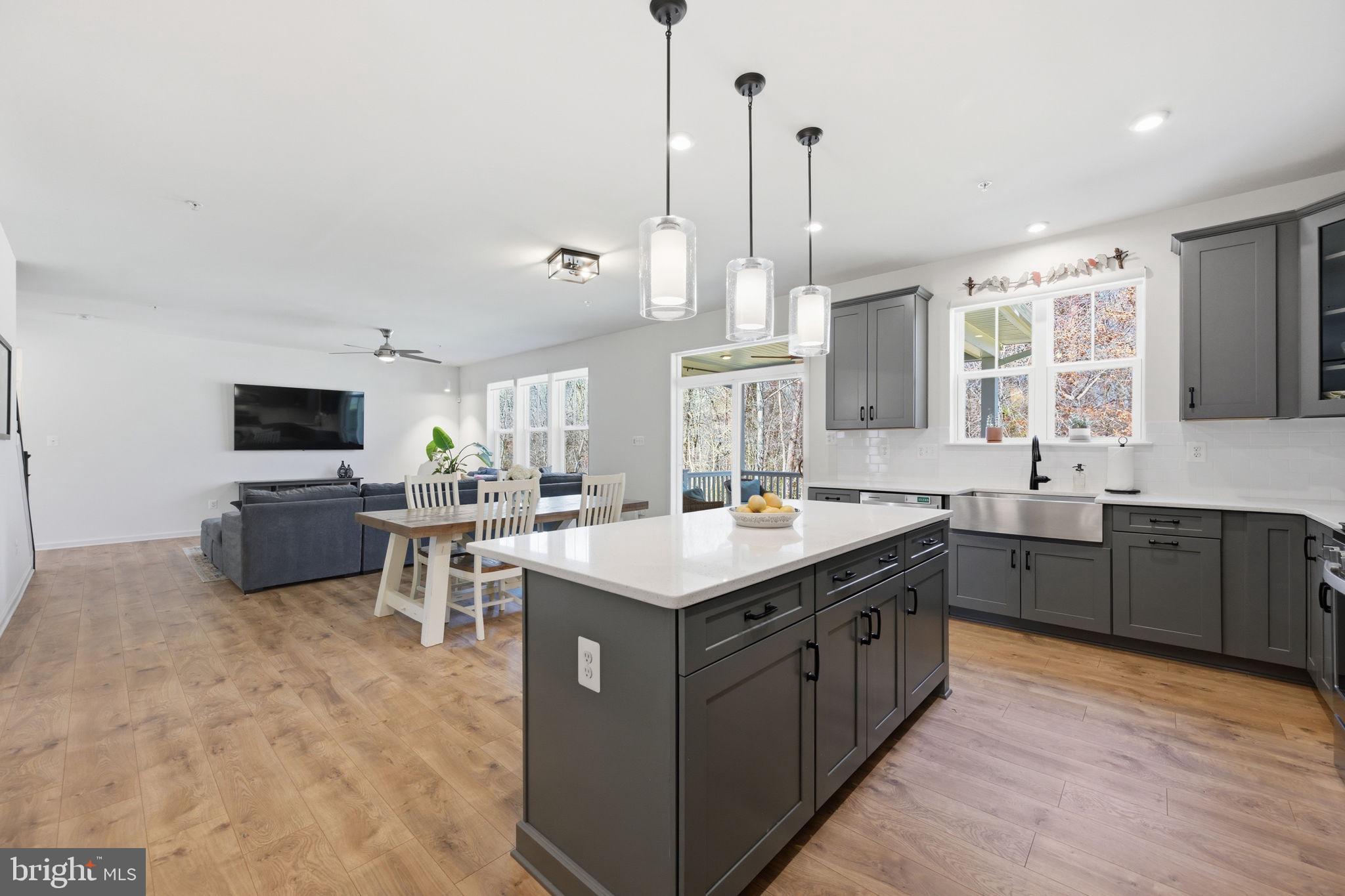 2397 Terrapin Crossing Jessup, MD 20794 - Photo 8 of 40 a kitchen with a stove a sink a counter top space and living room view