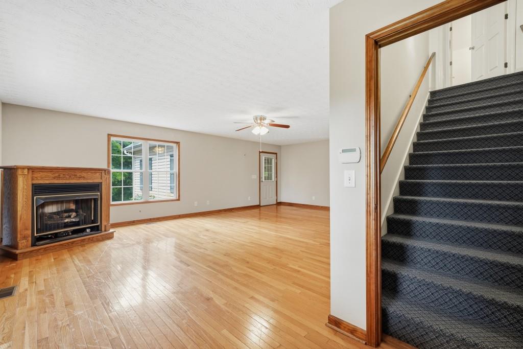 176 Big Oak Tree Road Northwest Adairsville, GA 30103 - Photo 26 of 77 a view of an empty room with wooden floor fireplace and a window