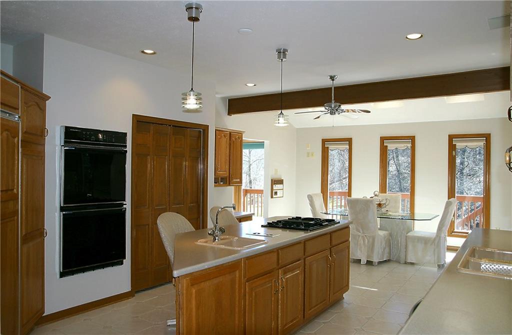 144 Reichold Road Wexford, PA 15090 - Photo 2 of 25 Design details work in harmony to enhance daily activities within the Kitchen! Featured are: Sub-Zero Refrigerator, Jenn-Air Gas Cooktop, Nutone Food Center, Corian Countertops & more!