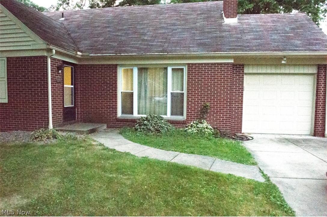 6714 Trenholm Road Youngstown, OH 44512 - Photo 22 of 22 View of front of house featuring a garage and a front yard