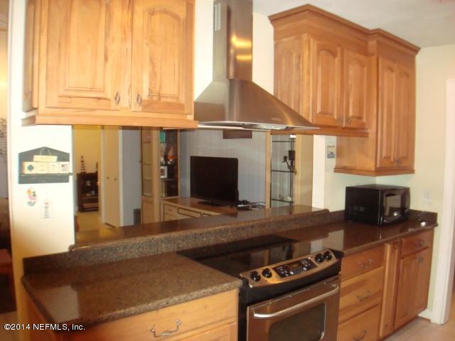 3980 Heidi Road West Jacksonville, FL 32277 - Photo 17 of 46 a kitchen with stainless steel appliances granite countertop a stove a sink and a microwave