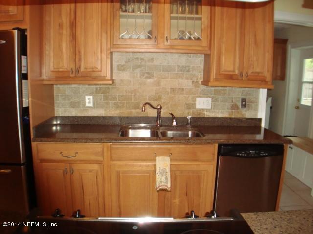 3980 Heidi Road West Jacksonville, FL 32277 - Photo 18 of 46 a kitchen with stainless steel appliances granite countertop a sink and cabinets