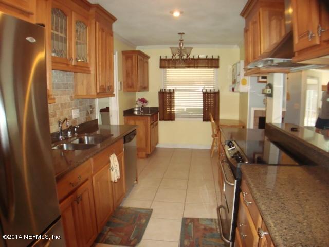 3980 Heidi Road West Jacksonville, FL 32277 - Photo 20 of 46 a kitchen with stainless steel appliances a refrigerator and a stove