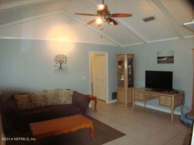 3980 Heidi Road West Jacksonville, FL 32277 - Photo 24 of 46 a living room with furniture and a flat screen tv