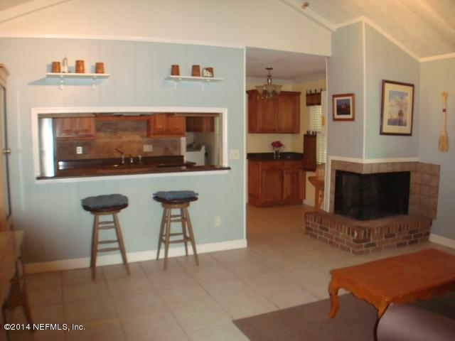 3980 Heidi Road West Jacksonville, FL 32277 - Photo 25 of 46 a living room with furniture a flat screen tv and a fireplace