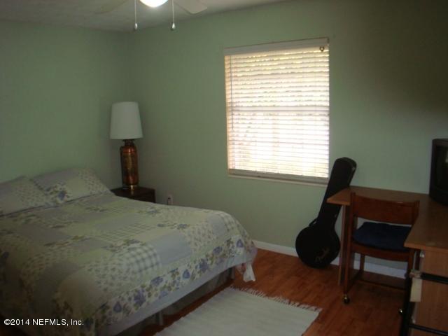 3980 Heidi Road West Jacksonville, FL 32277 - Photo 28 of 46 a bedroom with a bed and a window