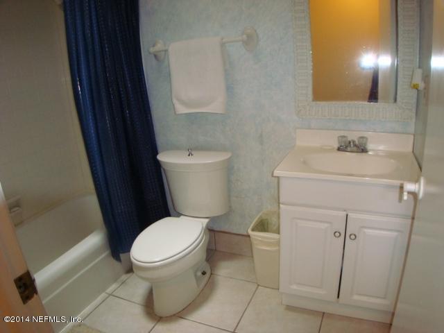 3980 Heidi Road West Jacksonville, FL 32277 - Photo 29 of 46 a white toilet sitting next to a bathroom sink