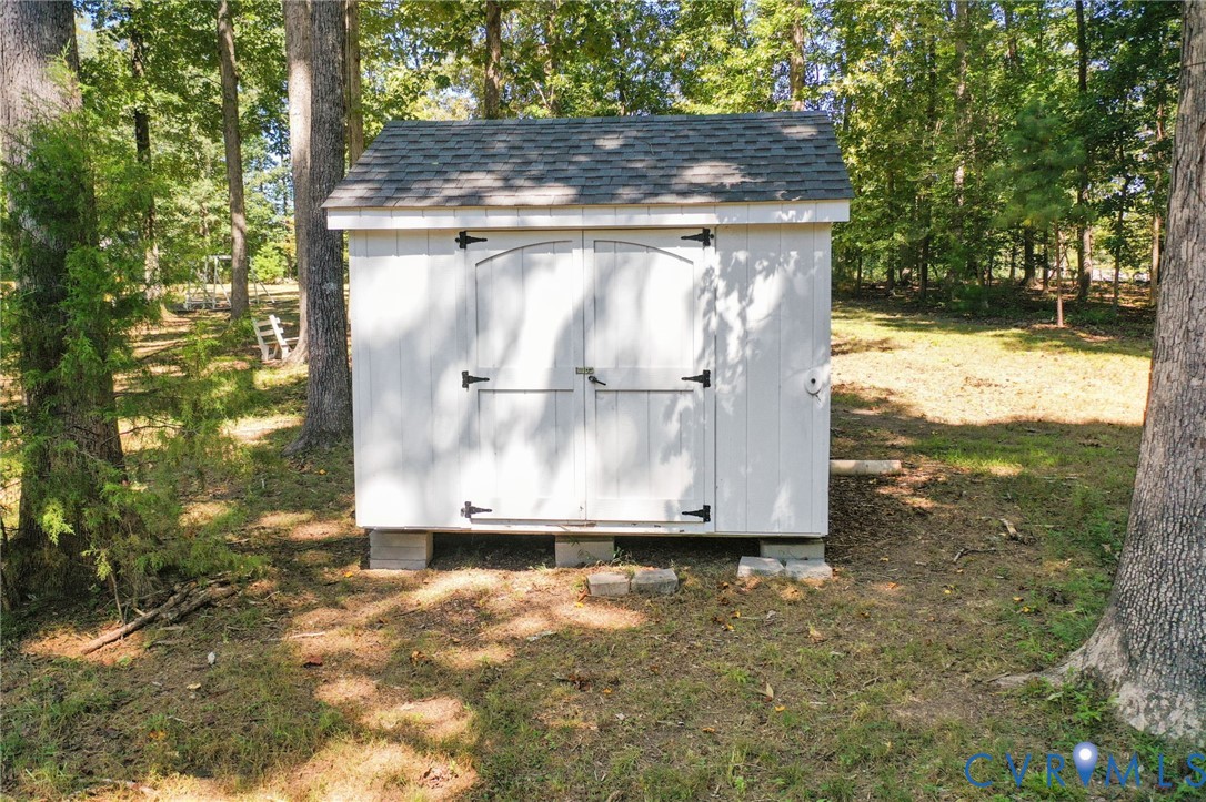 321 1st Flite Lane Manakin-Sabot, VA 23103 - Photo 11 of 11 a wooden bench sitting in middle of a forest