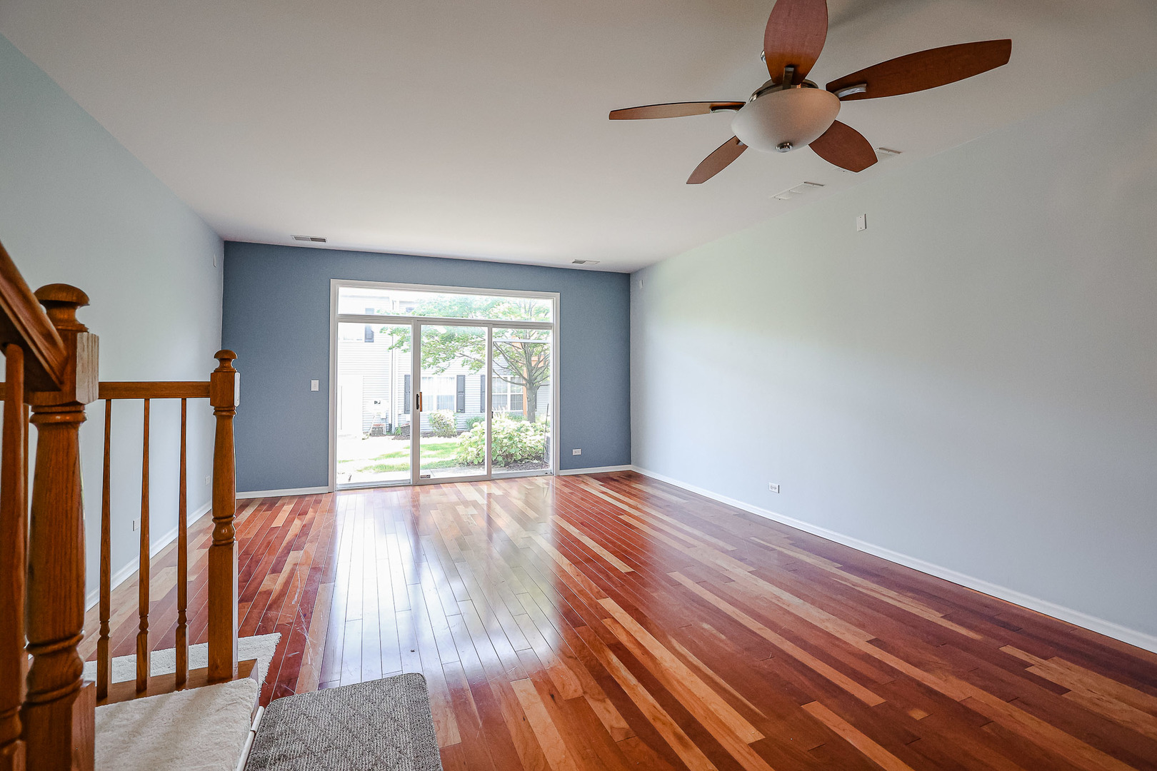 2439 Oneida Lane Naperville, IL 60563 - Photo 14 of 25 an empty room with wooden floor fan and windows