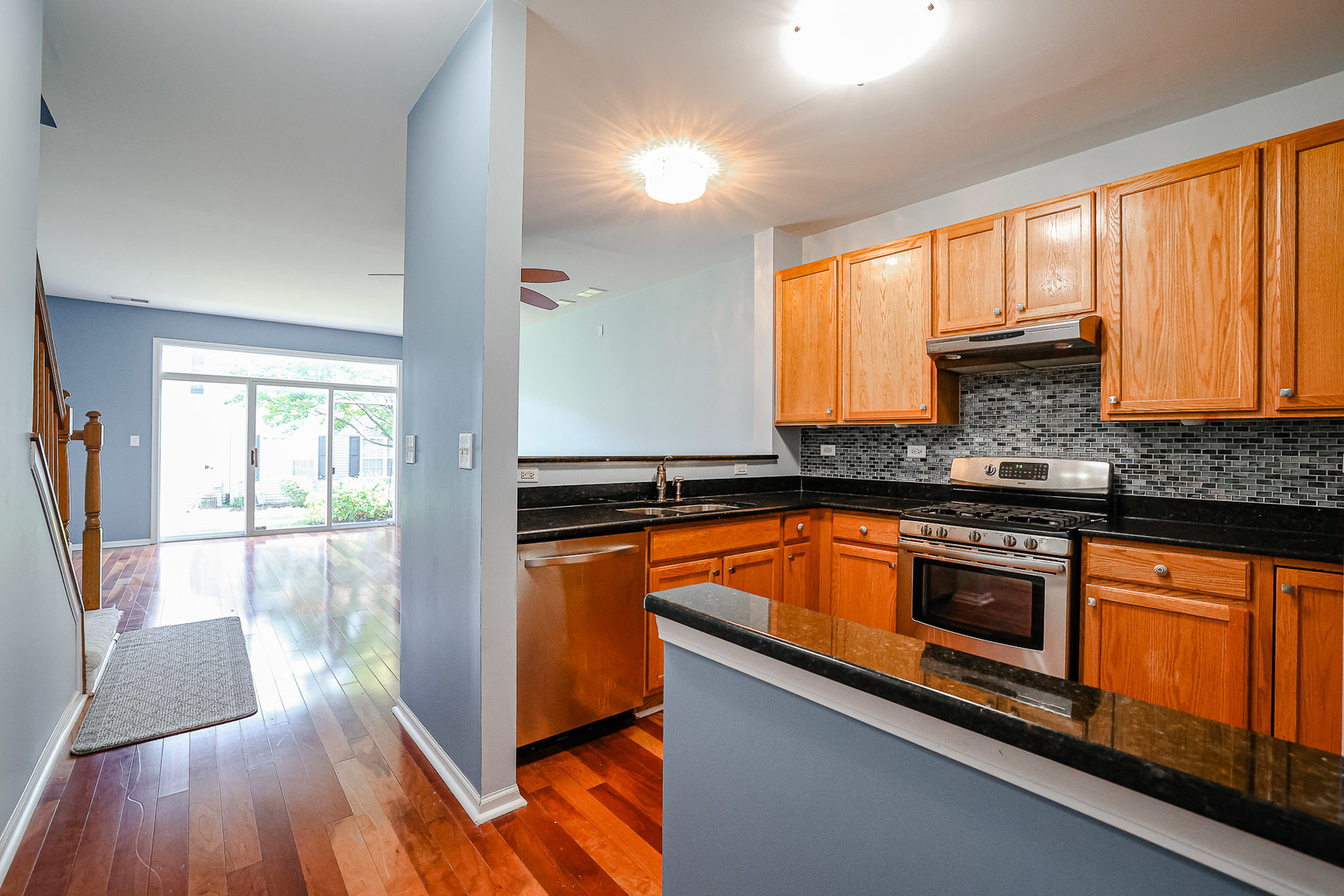 2439 Oneida Lane Naperville, IL 60563 - Photo 7 of 25 a kitchen with stainless steel appliances granite countertop a stove a sink and a microwave
