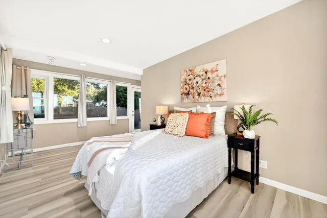 a living room with furniture a rug and a large window