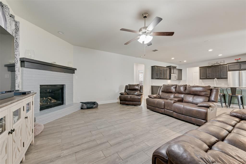 1279 Altuda Drive Forney, TX 75126 - Photo 12 of 35 a living room with furniture and a fireplace
