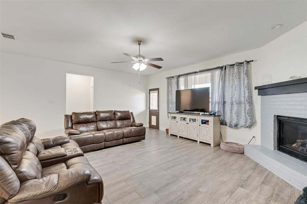 1279 Altuda Drive Forney, TX 75126 - Photo 13 of 35 a living room with furniture and a flat screen tv